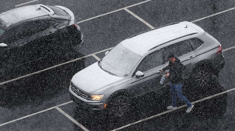 Workers have to remove snow from their cars Friday, Feb. 16, 2024 before going home. MARSHALL GORBY\STAFF
