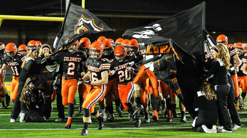 Coldwater’s Jared Pleiman (left), Neal Muhlenkamp (center) and Nate Rindler (right) lead the team on the field before a Div. V, Region 20 semifinal game on Saturday, November 12, 2016 at Sidney Memorial Stadium. Contributed Photo by Bryant Billing