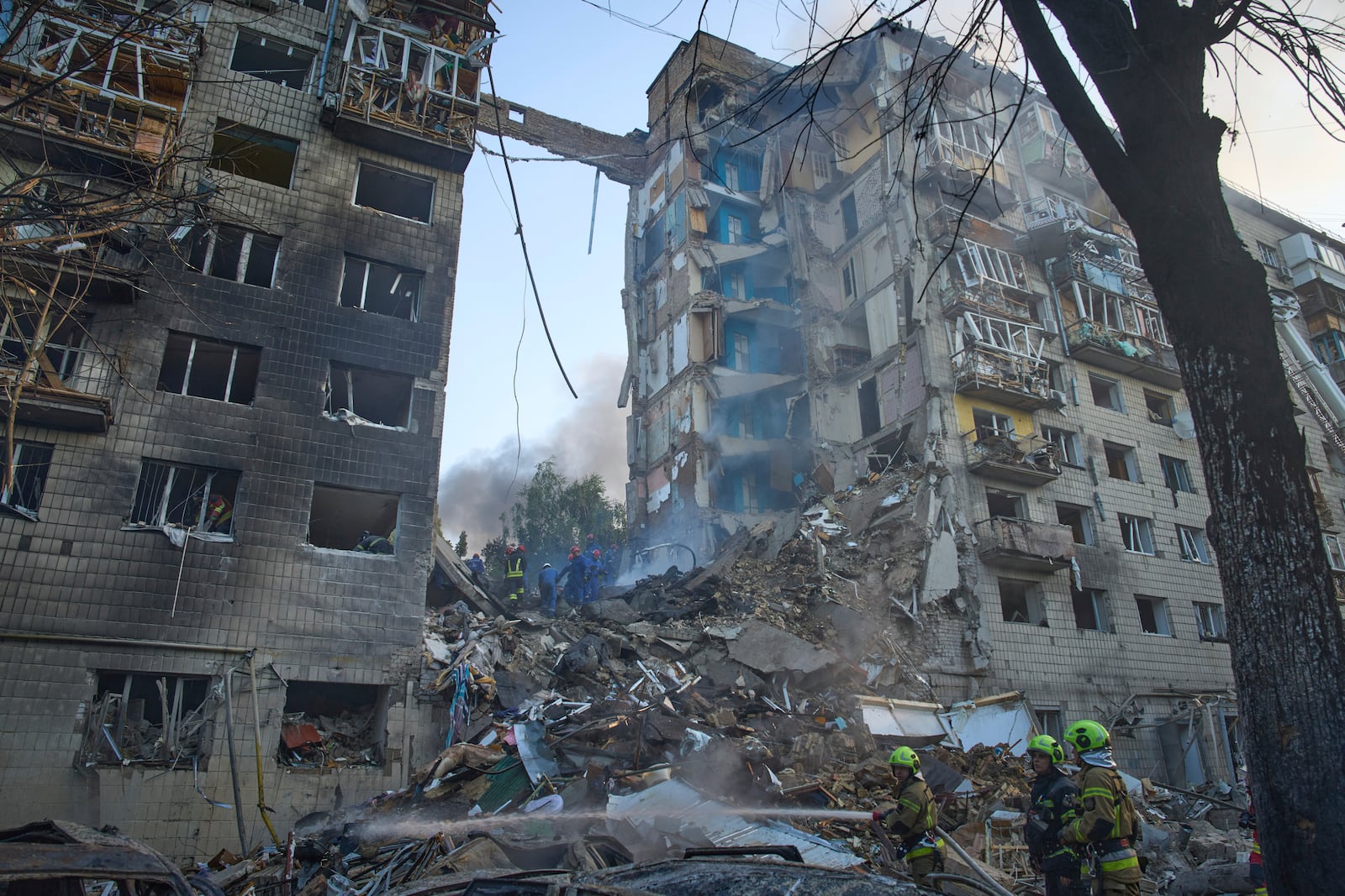 Firefighters put out the fire after a Russian missile hit a residential building during Russia's combined missile and drone air attack in Kyiv, Ukraine, Tuesday, June 17, 2025. (AP Photo/Efrem Lukatsky)