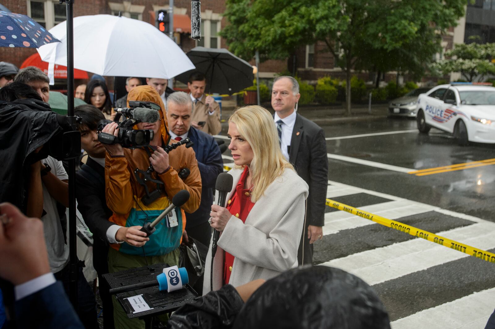 Attorney General Pam Bondi talks with reporters as law enforcement work the scene after two staff members of the Israeli Embassy in Washington were shot and killed outside the Capital Jewish Museum, Thursday, May 22, 2025, in Washington. (AP Photo/Rod Lamkey, Jr.)