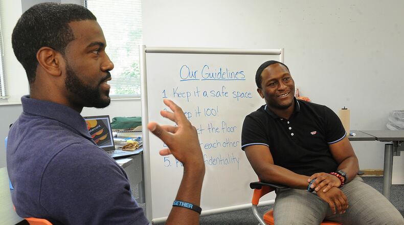 Ralph Davis Jr. (left) and Kelley Howard Jr. talk about their YWCA summer camp in Huber Heights that teaches boys how to be men. MARSHALL GORBY\STAFF