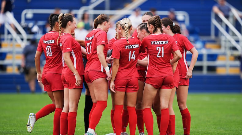 Dayton women's soccer players huddle during a scrimmage against Akron on Aug. 6 in Akron. Photo by David Cleveland