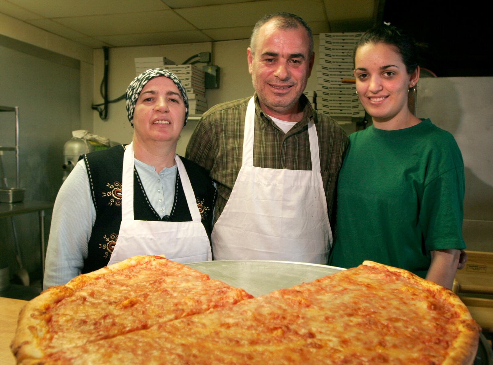 Troni's Pizza and Restaurant in Kettering is a family owned business. Pictured are Sami Troni (center) with his wife Nizafet (left) and daughter Hanife (right).