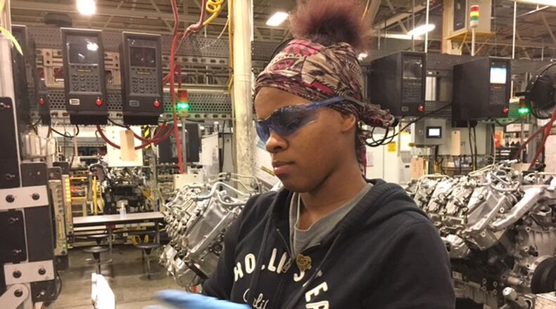 DMAX worker Stephanie Flowers helps assemble the famed Duramax diesel heavy-duty truck engine — the product of the DMAX plant. THOMAS GNAU/STAFF