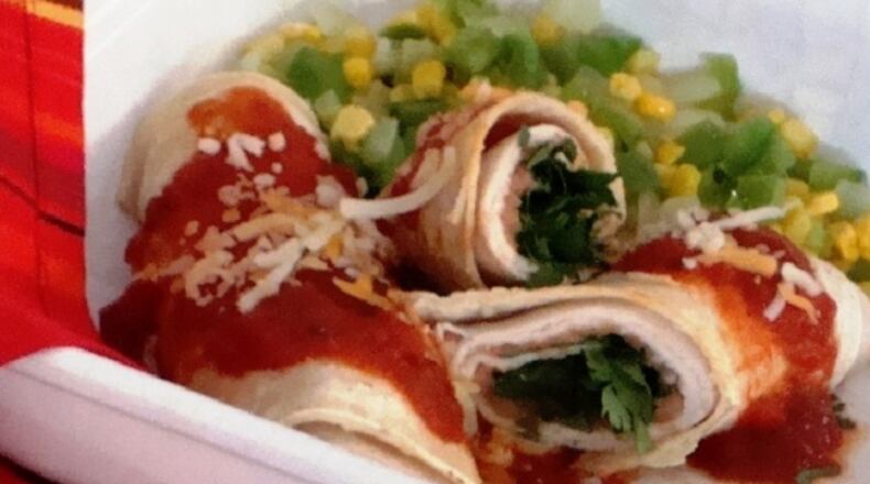 This Mexican-inspired turkey and refried bean enchiladas dish, here in a 2008 file image, takes just five minutes in the microwave. (Linda Gassenheimer/TNS)