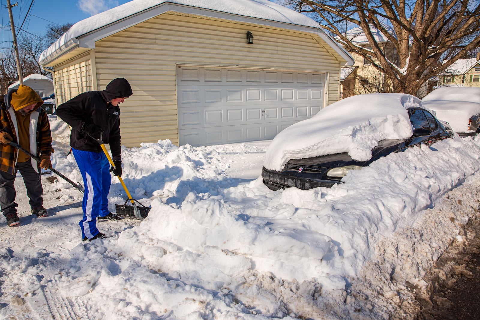 Miamisburg resident Eddie Sumpter Jr. and his son dig his son's car out of the snow on Tuesday, Jan. 27. CONTRIBUTED