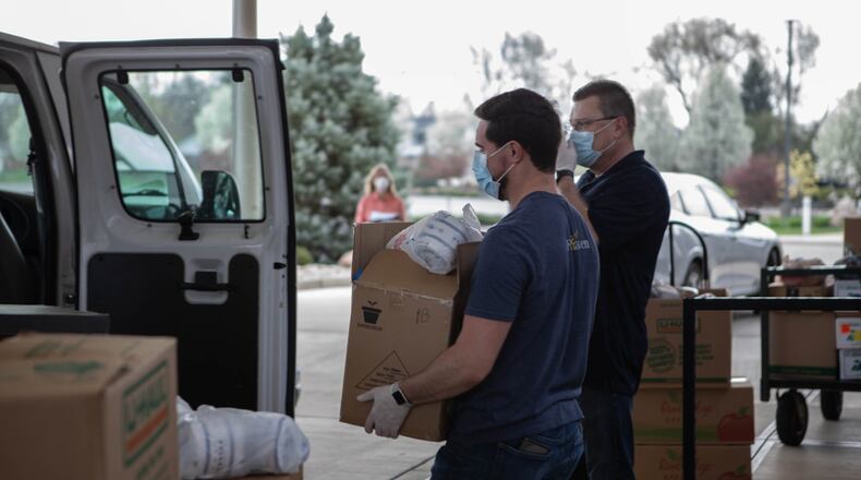 Church volunteers help unload food donations.