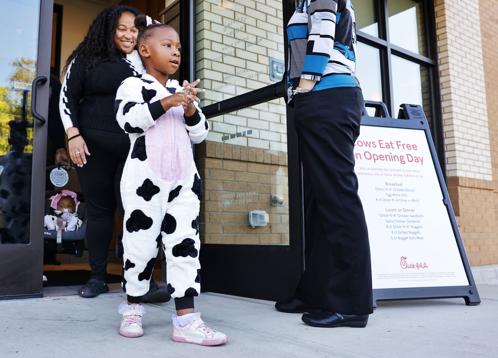 Percia Thomas, 4, dressed in a cow costume, walks out of Chick-Fil-A on Culbertson Road in Middletown on opening day Thursday, Sept. 18, 2025. The restaurant gave away free entrees to customers wearing cow attire. NICK GRAHAM/STAFF
