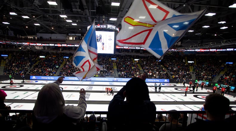 Fans wave Newfoundland and Labrador flags during Draw 5 at the Brier curling event in St. John's, Newfoundland and Labrador, Sunday, March 1, 2026. (Paul Daly/The Canadian Press via AP)