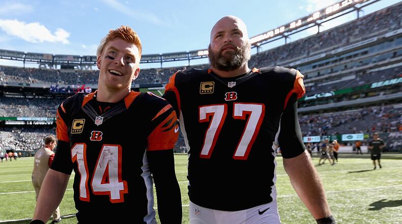 EAST RUTHERFORD, NJ - SEPTEMBER 11: Teammates Andy Dalton #14 and Andrew Whitworth #77 of the Cincinnati Bengals celebrate after a 23-22 victory over the New York Jets during their game at MetLife Stadium on September 11, 2016 in East Rutherford, New Jersey. (Photo by Streeter Lecka/Getty Images)