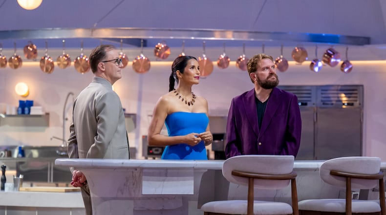 This image released by CBS shows, from left, Wylie Dufresne, Padma Lakshmi, and Michael Cimarusti on the set of the cooking competition series "America's Culinary Cup." (Jackie Brown/CBS via AP)