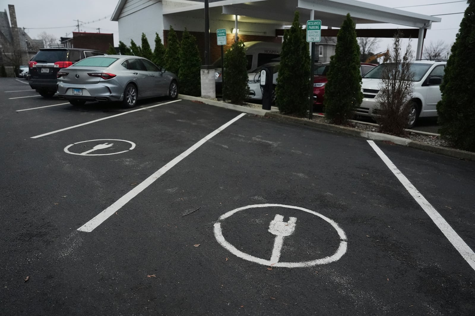 Electric vehicle parking spots sit near charging stations, Friday, April 11, 2025, in Evansville, Ind. (AP Photo/Joshua A. Bickel)