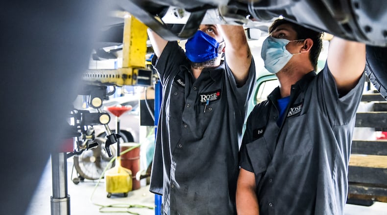 Nathan Sweetland. left, and Erik Rumpke work on a truck at Rose Automotive Thursday, July 9, 2020 in Hamilton. NICK GRAHAM / STAFF