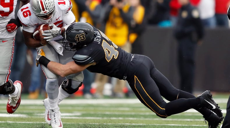 Ohio State quarterback J.T. Barrett (16) is tackled by Iowa linebacker Josey Jewell during the first half of an NCAA college football game, Saturday, Nov. 4, 2017, in Iowa City, Iowa. (AP Photo/Charlie Neibergall)