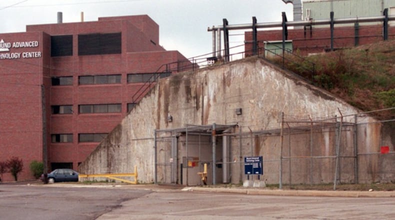 This photograph taken in 1997 shows one of the two entrances to T building on the grounds of Mound Lab in Miamisburg. The building, five stories underground (the newer building on the left is about five stories), is where Monsanto Chemical developed triggering device for the atomic bomb during World War II. This entrance is at the top of the secret installations that was built by carving out the earth on the other side of this hill, building the building and then packing the dirt back around it. FILE PHOTO
