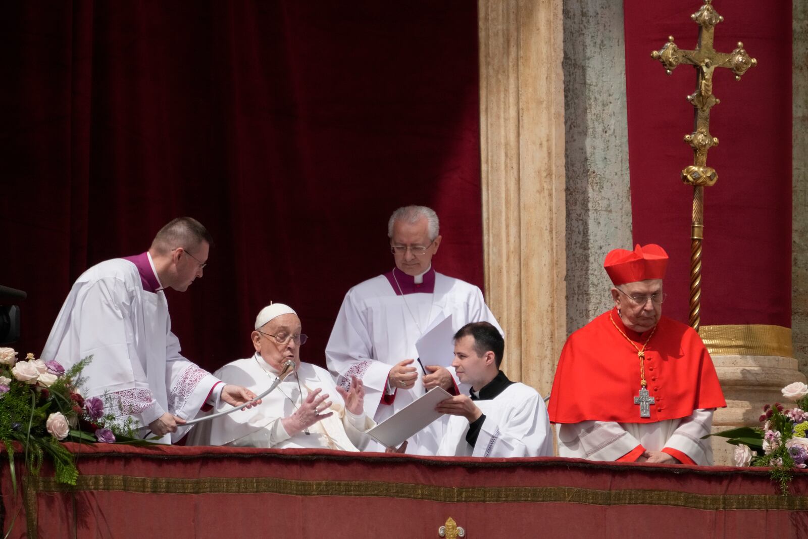 Pope Francis bestows the Urbi et Orbi (Latin for to the city and to the world) blessing from the central lodge of St. Peter's Basilica at the end of the Easter mass presided over by Cardinal Angelo Comastri in St. Peter's Square at the Vatican Sunday, April 20, 2025. (AP Photo/Gregorio Borgia)