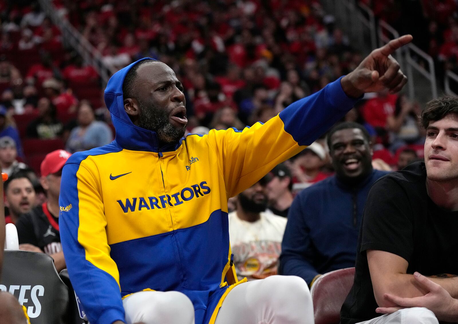 Golden State Warriors' Draymond Green yells at Houston Rockets fans from the bench after leaving the game during the second half of Game 2 of an NBA basketball first-round playoff series against the Houston Rockets in Houston, Wednesday, April 23, 2025. (AP Photo/Karen Warren)