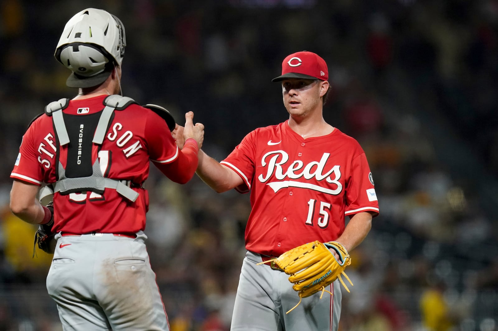 Cincinnati Reds pitcher Emilio Pagan, right, celebrates with catcher Tyler Stephenson, left, after getting the final out of a baseball game against the Pittsburgh Pirates, Saturday, Aug. 9, 2025, in Pittsburgh. (AP Photo/Matt Freed)