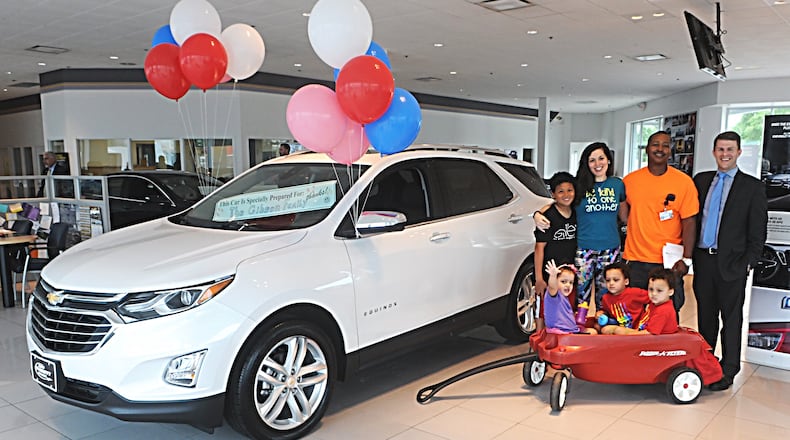 The Gibson Family with Jay Schmitt picking up their new car at the Jeff Schmitt Auto Group in Fairborn Friday. The Car was a gift from Ellen DeGeneres and Chevrolet. Photo Marshall Gorby