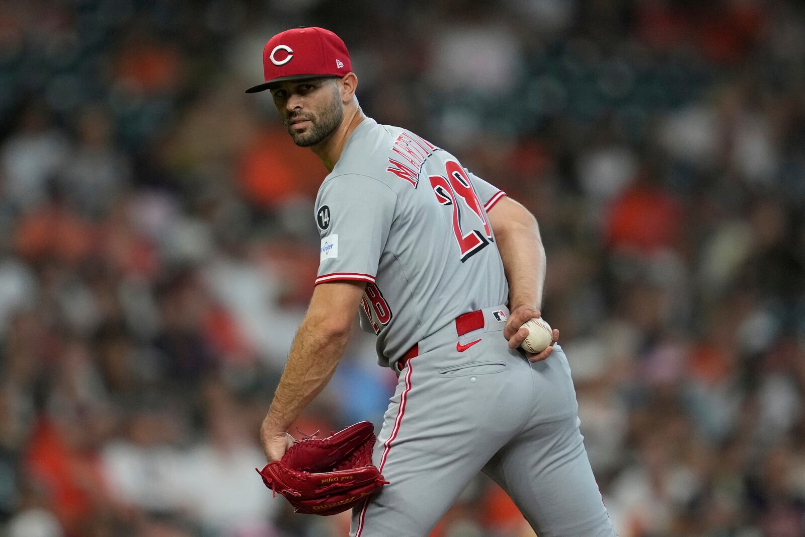 Cincinnati Reds starting pitcher Nick Martinez (28) looks back at first base during the first inning of a baseball game against the Houston Astros in Houston, Friday, May 9, 2025. (AP Photo/Ashley Landis)