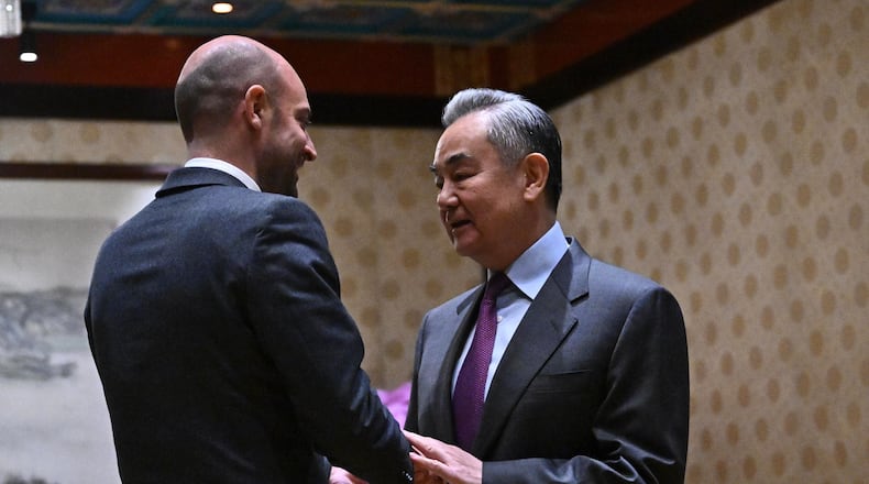 France's Foreign Affairs Minister Jean-Noel Barrot, left, and Chinese Foreign Minister Wang Yi shake hands before their meeting at the Diaoyutai State Guesthouse in Beijing, China, Wednesday, Dec. 3, 2025. (Pedro Pardo/Pool Photo via AP)