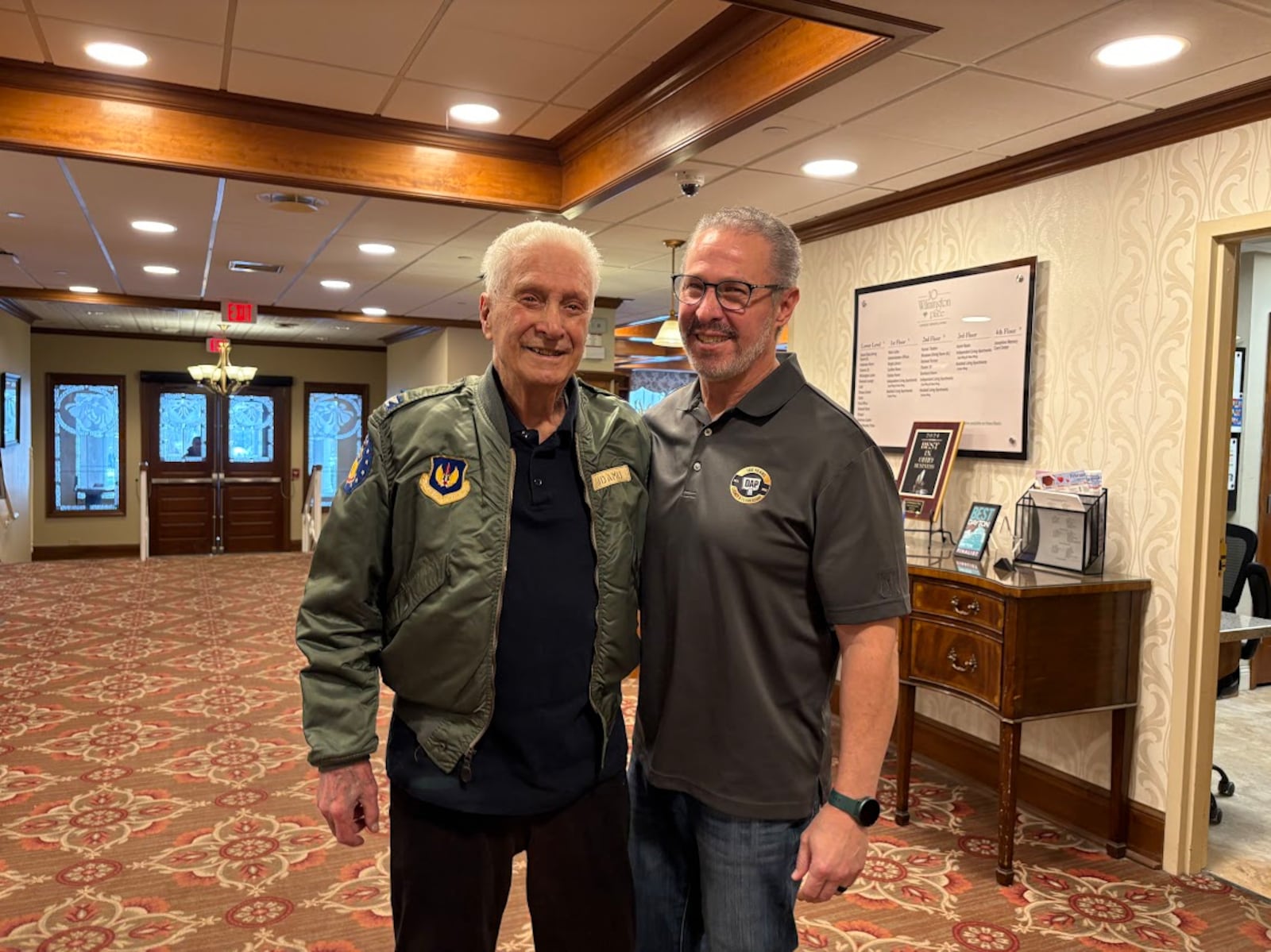 Father and son, both named Joseph Adamo. The older Mr. Adamo, left, celebrates his 100th birthday Feb. 11. His son is 65. The elder Adamo lives at the 10 Wilmington Place retirement community in Dayton, where this photo was taken Feb. 2, 2026. THOMAS GNAU/STAFF