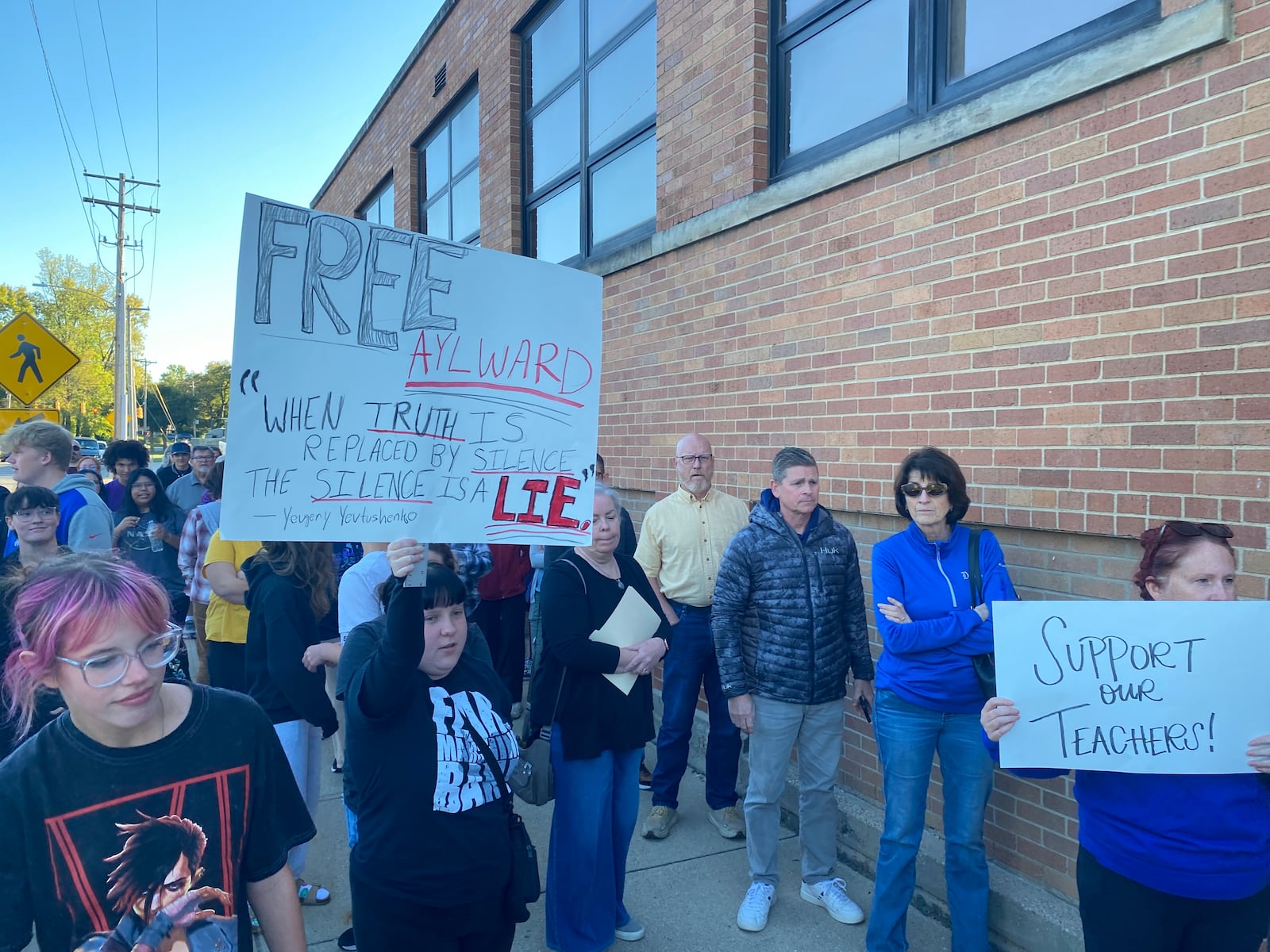 Miamisburg community members show their support for two teachers who previously were placed under paid administrative leave during a protest before the board meeting Thursday, Oct. 9, 2025. ERIC SCHWARTZBERG / STAFF