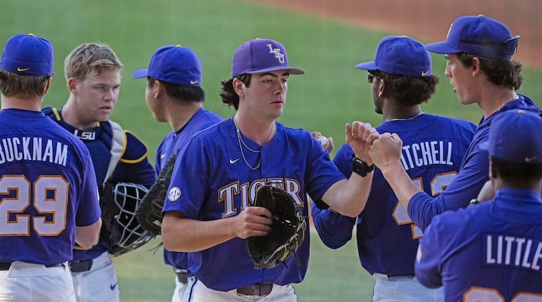 LSU starting pitcher Luke Holman (38) greets his teammates after pitching the first inning against Vanderbilt during an NCAA college baseball game Thursday, April 4, 2024, in Baton Rouge, La. (Hilary Scheinuk/The Advocate via AP)