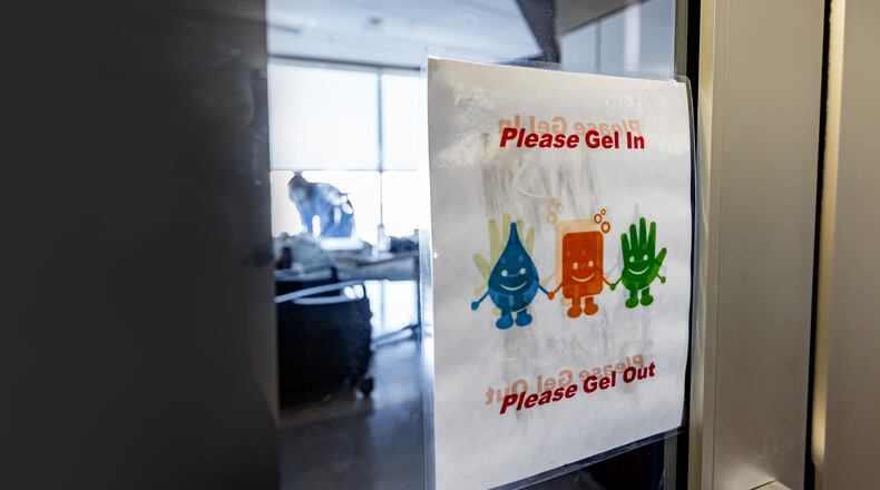 MVH signage on the door as a nurse works with COVID patient in the background, from 2020.  CONTRIBUTED BY PREMIER HEALTH