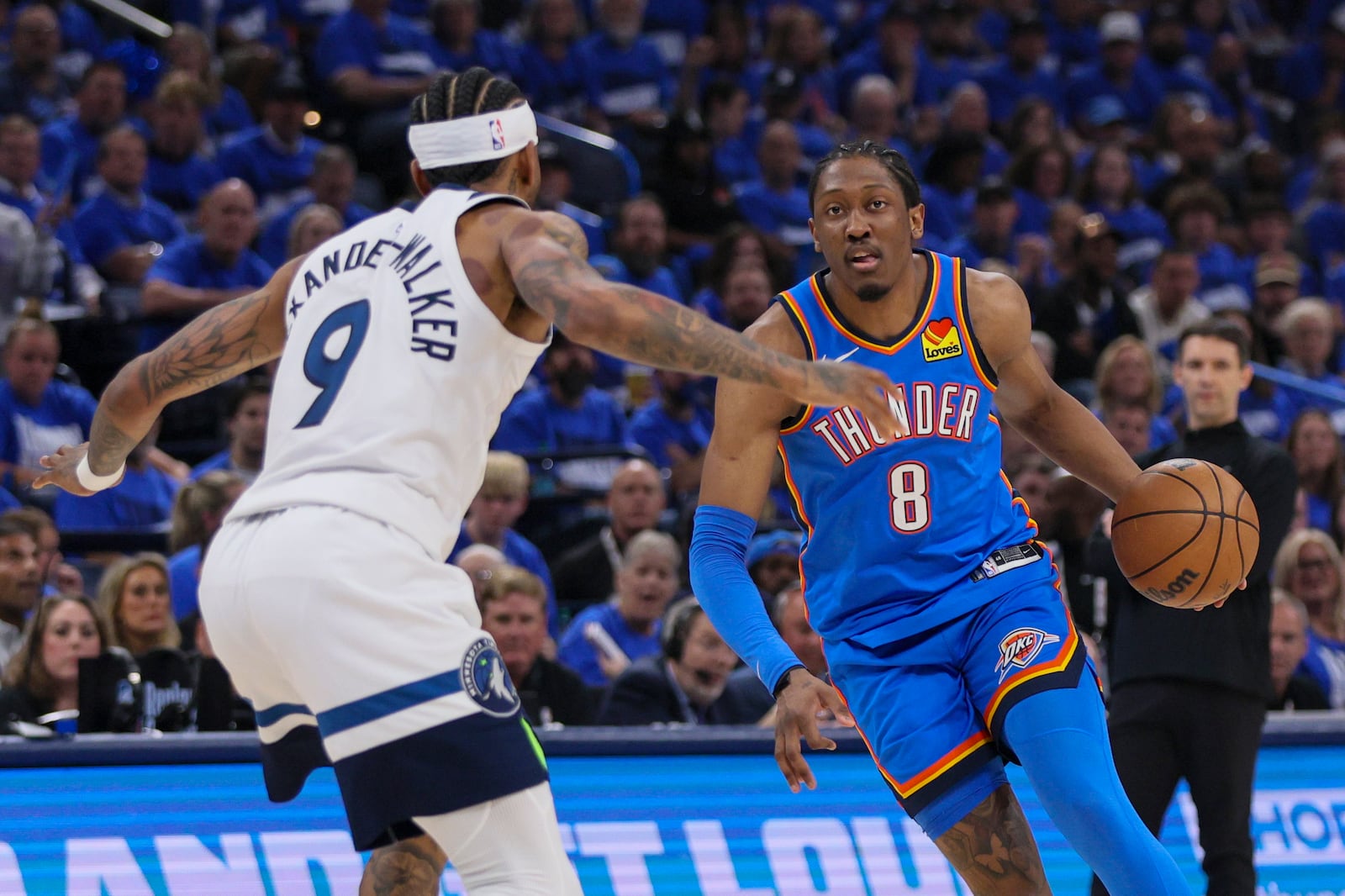 Oklahoma City Thunder forward Jalen Williams (8) drives against Minnesota Timberwolves guard Nickeil Alexander-Walker (9) during the first half of Game 2 of an NBA basketball Western Conference Finals playoff series Thursday, May 22, 2025, in Oklahoma City. (AP Photo/Nate Billings)