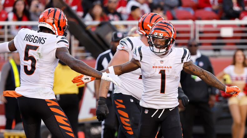 Cincinnati Bengals wide receiver Ja'Marr Chase (1) is congratulated by wide receiver Tee Higgins (5) after scoring against the San Francisco 49ers during the second half of an NFL football game in Santa Clara, Calif., Sunday, Oct. 29, 2023. (AP Photo/Josie Lepe)