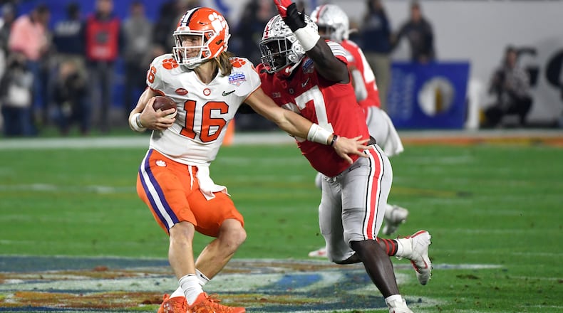 GLENDALE, ARIZONA - DECEMBER 28: Trevor Lawrence #16 of the Clemson Tigers is hit by Robert Landers #67 of the Ohio State Buckeyes in the first half during the College Football Playoff Semifinal at the PlayStation Fiesta Bowl at State Farm Stadium on December 28, 2019 in Glendale, Arizona. (Photo by Norm Hall/Getty Images)