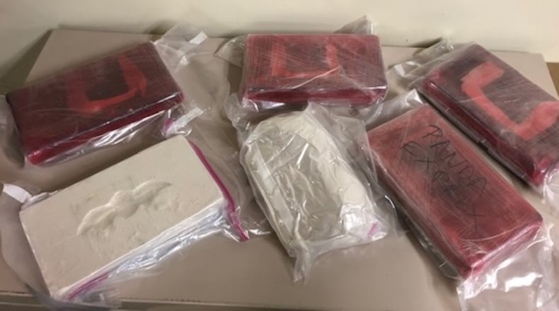 Authorities seized 12 pounds of suspected heroin following a longterm drug trafficking investigation in the Miami Valley.