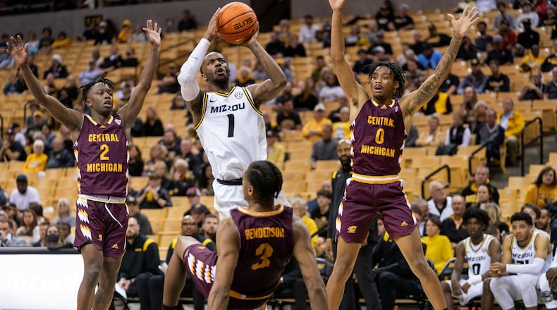 Missouri's Amari Davis, top center, shoots past Kevin Miller, left, Brian Taylor, right, and Harrison Henderson during the second half of an NCAA college basketball game Tuesday, Nov. 9, 2021, in Columbia, Mo. (AP Photo/L.G. Patterson)