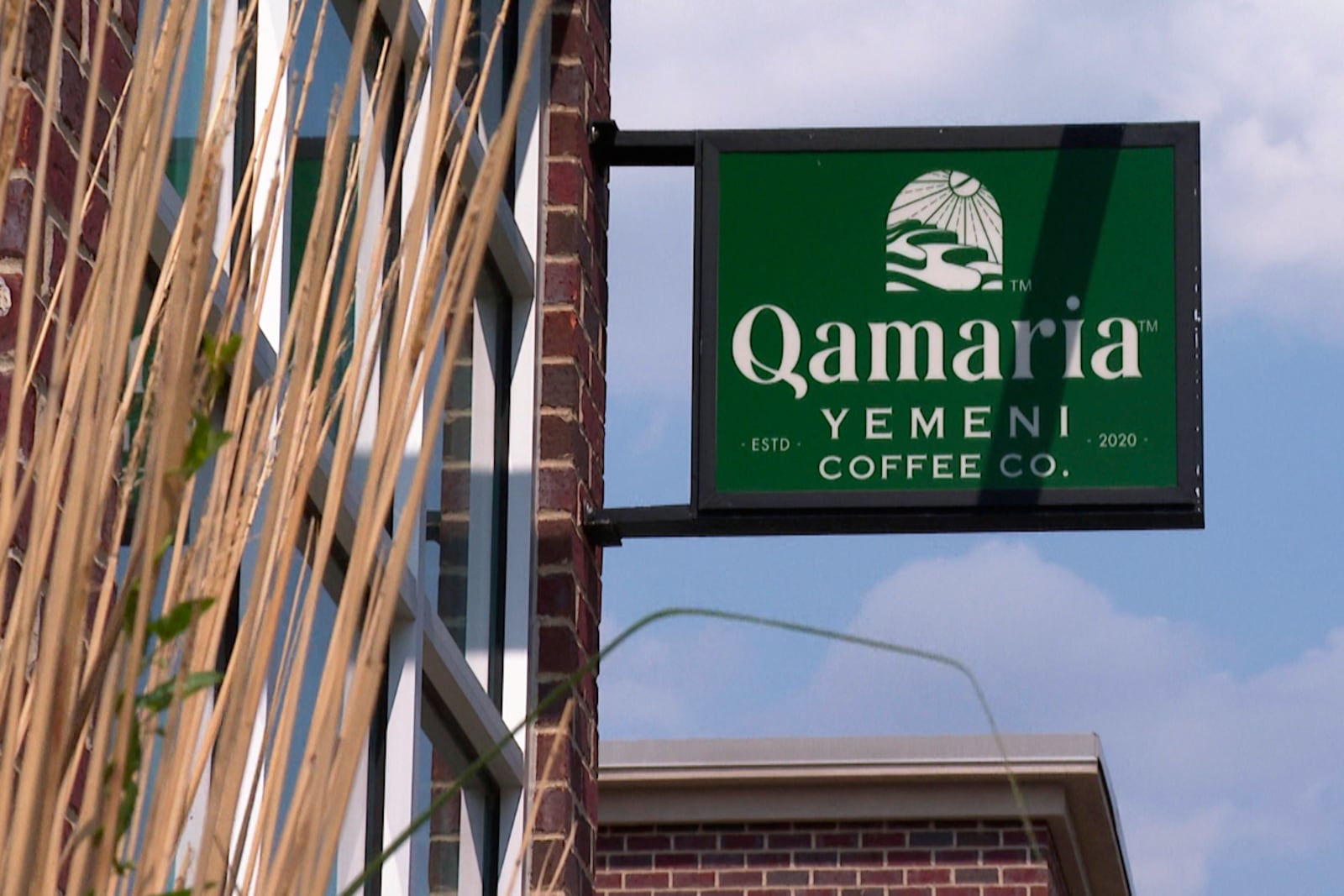 In this image made from video, a sign welcomes patrons to the Qamaria Yemeni Coffee Co. Monday, June 9, 2025, in Dearborn, Mich. (AP Photo/Mike Householder)