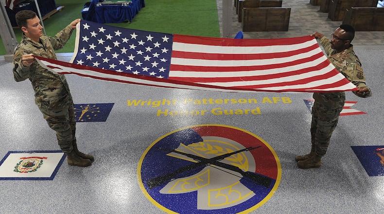 Staff Sgt. Rodney Petrie, left, and MSgt Joshua Lane, Superintendent, Base Honor Guard practice a two man flag fold drill. MARSHALL GORBY\STAFF