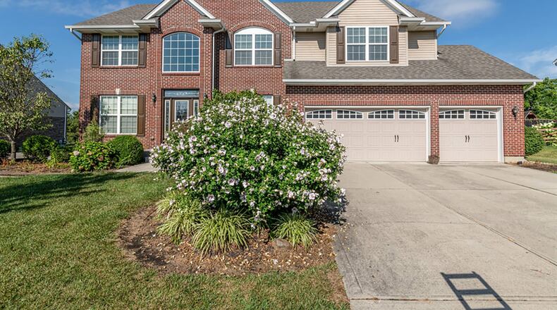 The brick-and-frame house has nearly 4,000 sq. ft. of living space with a finished basement that has above-grade windows. A concrete driveway leads up to the 3-car garage. CONTRIBUTED PHOTO