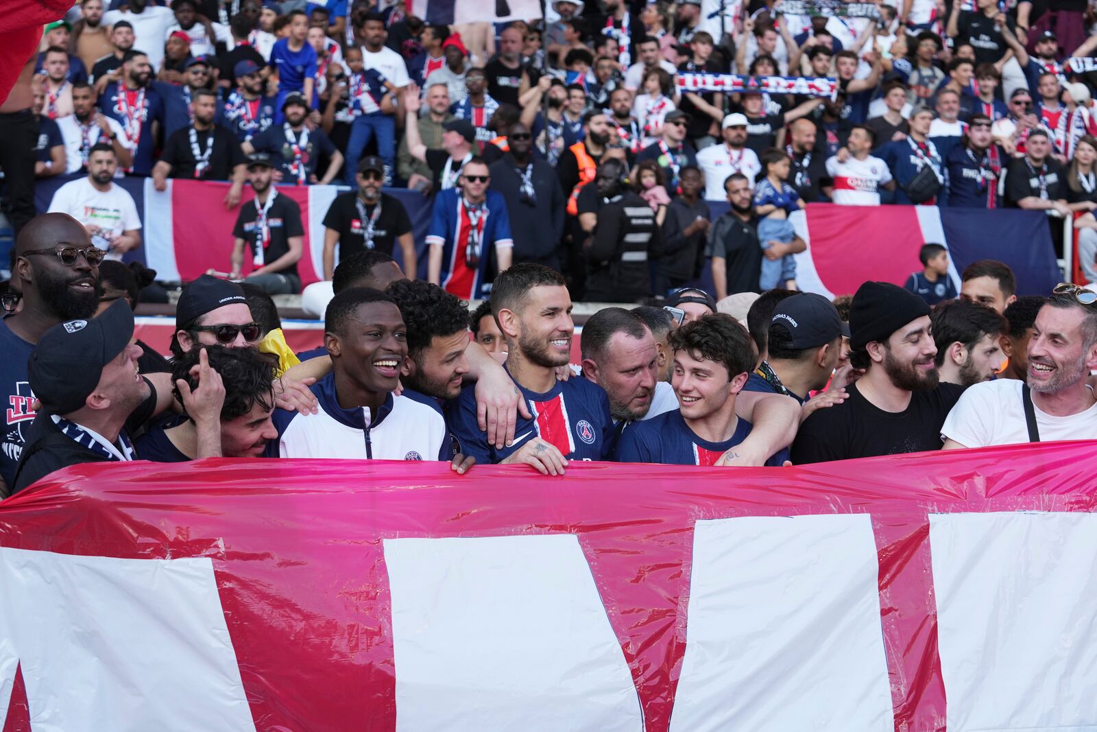 PSG's supporters celebrate winning the French League One championship title after the soccer match between Paris Saint-Germain and Angers at Parc des Princes stadium in Paris, Saturday, April 5, 2025. (AP Photo/Michel Euler)