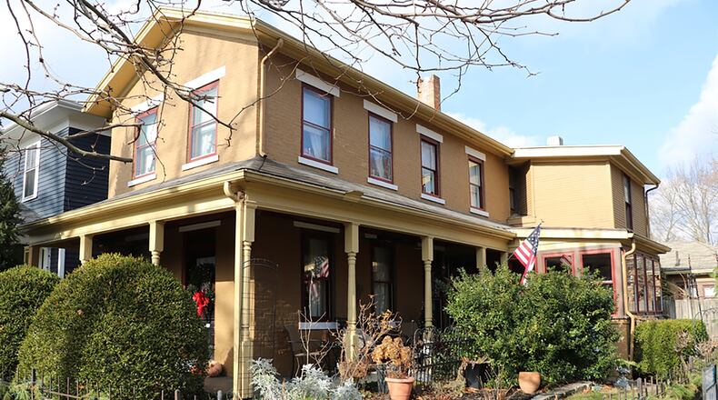 A wraparound porch allows for both formal and casual entrances into the two-story historical home located within the Dayton Oregon District.