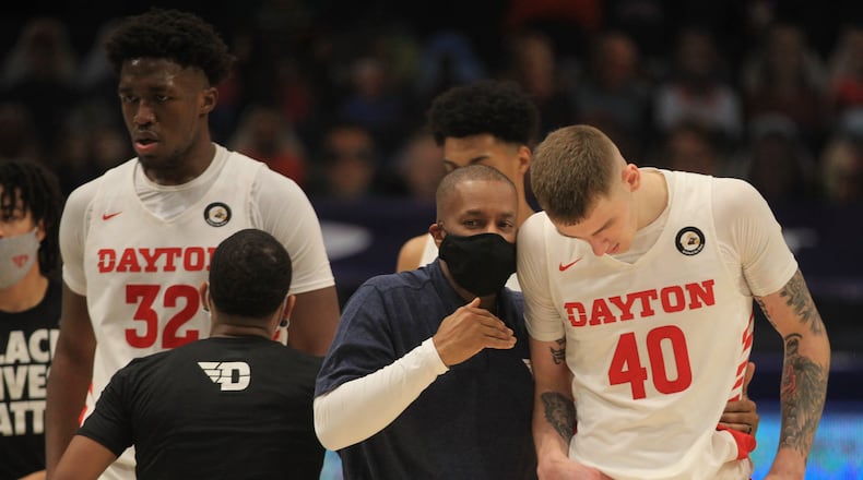 Dayton's Anthony Solomon talks to Chase Johnson during a game against Mississippi on Saturday, Dec. 19, 2020, at UD Arena. David Jablonski/Staff
