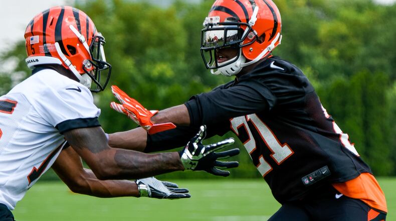Darqueze Dennard, right, defends Mario Alford on the first day of the Cincinnati Bengals training camp on her birthday Friday, July 29 at their practice fields near Paul Brown Stadium in Cincinnati. NICK GRAHAM/STAFF