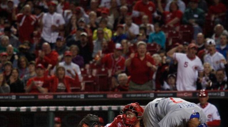 Reds catcher Corky Miller blocks home plate, preventing the Cubs’ Dave Sappelt from scoring on Tuesday. David Jablonski/Staff