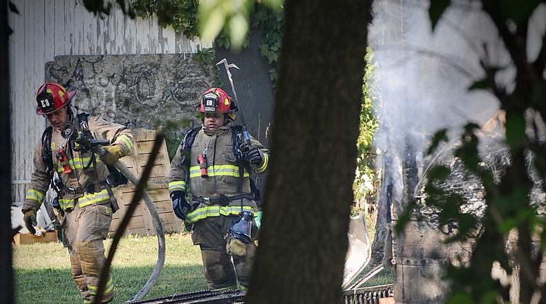 Members of the Dayton Fire Department battle a house, fire on Valley Street Wednesday, Sept. 13, 2023 MARSHALL GORBY \STAFF