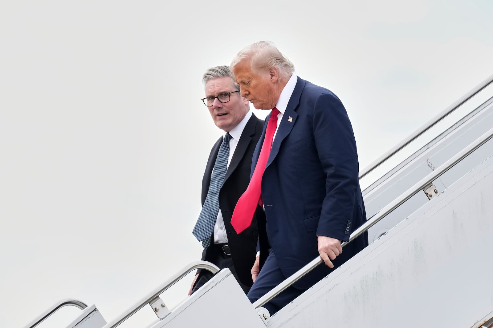 President Donald Trump and Britain's Prime Minister Keir Starmer exit Air Force One as they arrive at Royal Air Force Lossiemouth en route to Aberdeen, Scotland Monday, July 28, 2025. (AP Photo/Jacquelyn Martin)