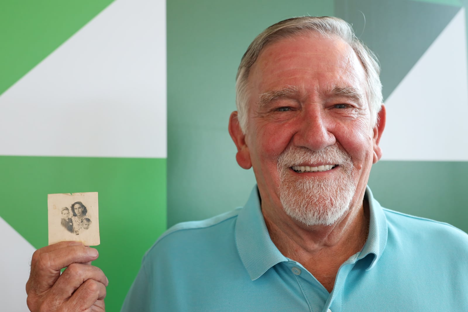 Robert Salinas was photographed holding a memory of his family's immigration journey. CONTRIBUTED