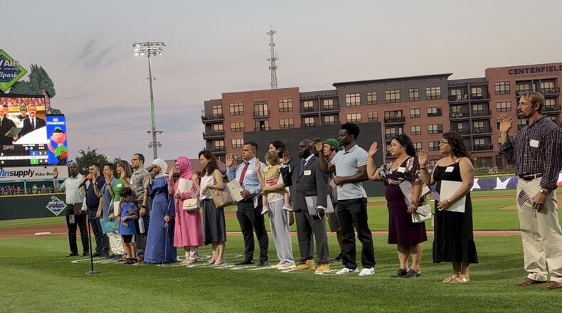 Twenty new United States citizens recited the oath that officially made them American citizens Tuesday Aug. 27, 2024, at a naturalization ceremony hosted by the Dayton Dragons between the third and fourth inning at Day Air Ballpark. CONTRIBUTED PHOTO