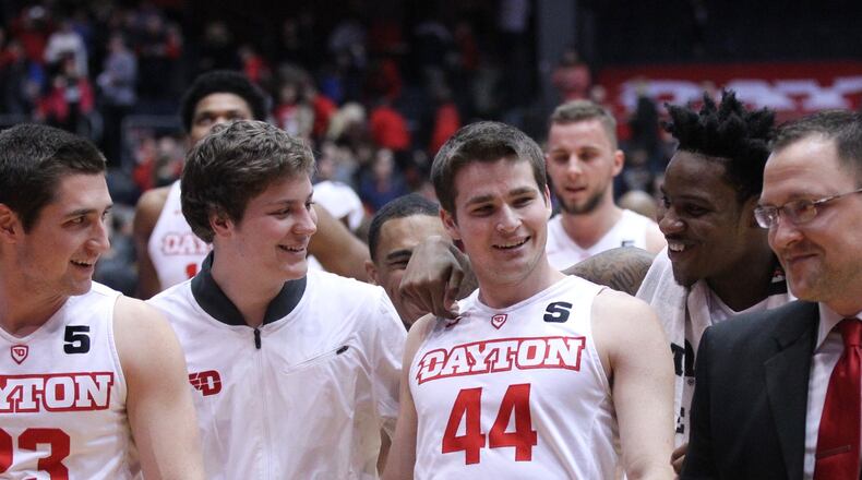 Dayton players (left to right) Jack Westerfield, Dalton Stewart, Joey Gruden and John Crosby and coach Andy Farrell (far left) leave the court after a victory against Virginia Commonwealth on Friday, Jan. 12, 2018, at UD Arena. David Jablonski/Staff