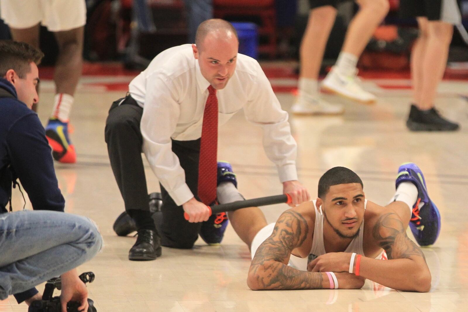 Dayton’s Obi Toppin gets help warming up from graduate assistant coach James Haring before a game against Massachusetts on Feb. 15, 2020, at the Mullins Center in Amherst, Mass. David Jablonski/Staff