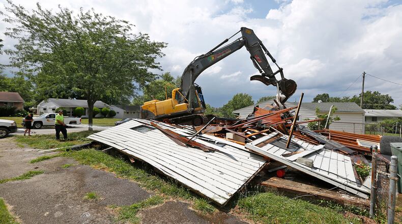 In this July 2019 photo, a Bladecutters Inc. crew is tearing down houses for the Montgomery County Land Bank. The company is not involved in the lawsuit reported in this story.  TY GREENLEES / STAFF