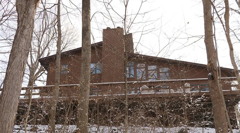 A 2-story solarium has terra-cotta tile flooring, floor-to-ceiling windows, skylights and brick wall accents. The solarium also has access to the deck.